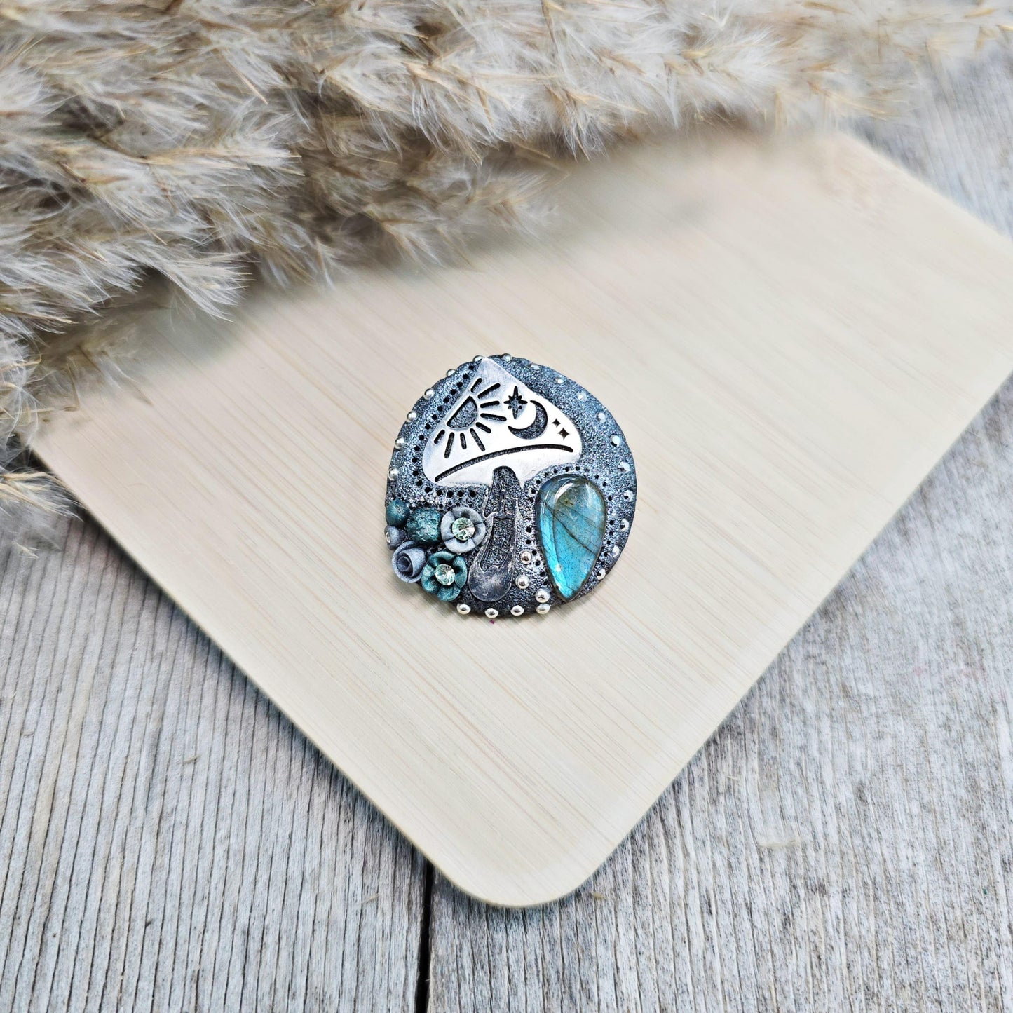 Handmade polymer clay brooch featuring a magical mushroom and a glowing labradorite stone, with stainless steel pin – forest-inspired mystical jewelry.