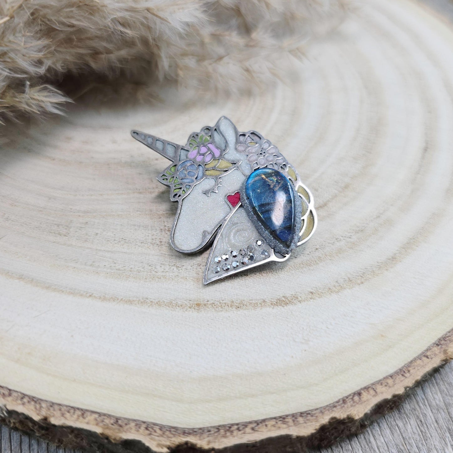 Handmade unicorn brooch featuring a shimmering labradorite, crafted from polymer clay with stainless steel backing – magical and unique fantasy jewelry.
