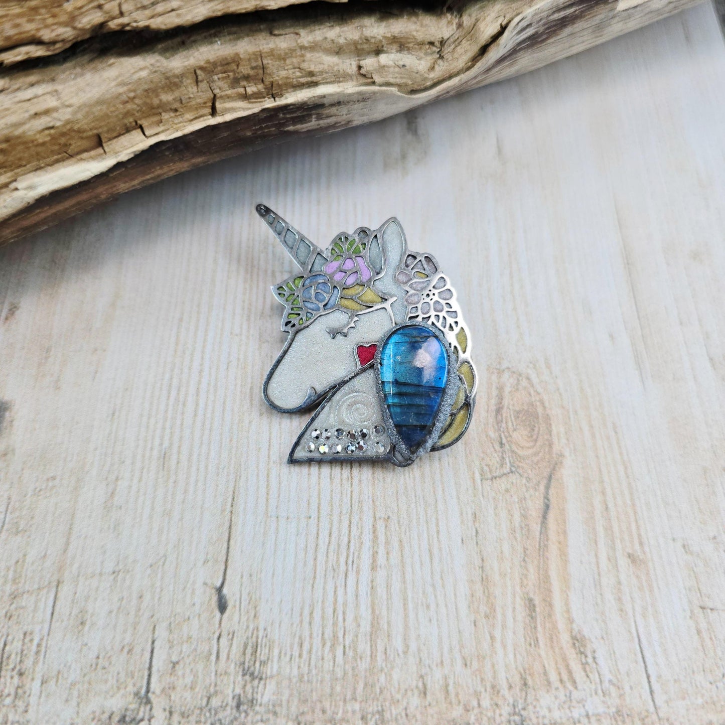 Handmade unicorn brooch featuring a shimmering labradorite, crafted from polymer clay with stainless steel backing – magical and unique fantasy jewelry.