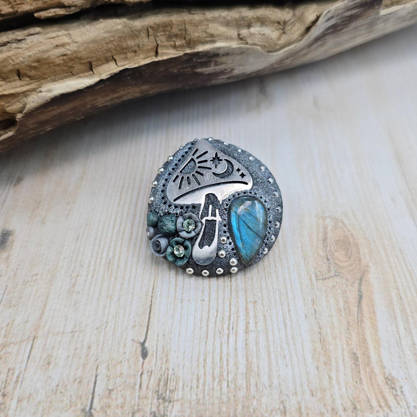 Handmade polymer clay brooch featuring a magical mushroom and a glowing labradorite stone, with stainless steel pin – forest-inspired mystical jewelry.