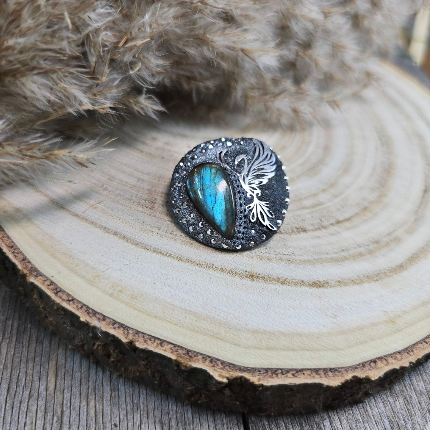 Handmade phoenix brooch with natural labradorite – crafted from polymer clay and stainless steel. Unique mystical jewelry symbolizing rebirth and transformation.