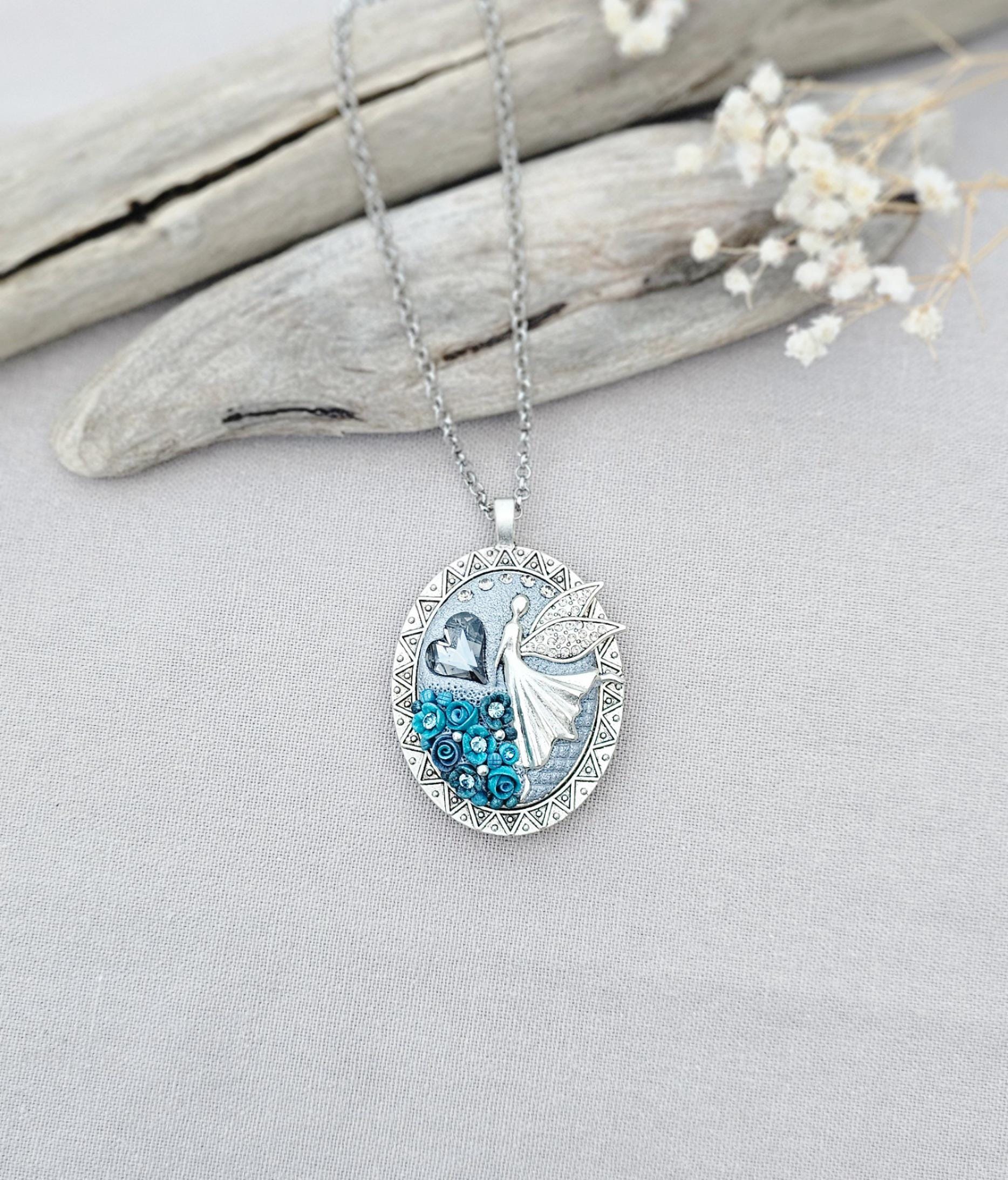 turquoise flower pendant, black crystal charm, fairy locket, silver fairy necklace, unique gift, magical jewelry, photo locket, handcrafted pendant, vibrant floral, elegant accessory, mystical charm, long chain necklace, whimsical locket