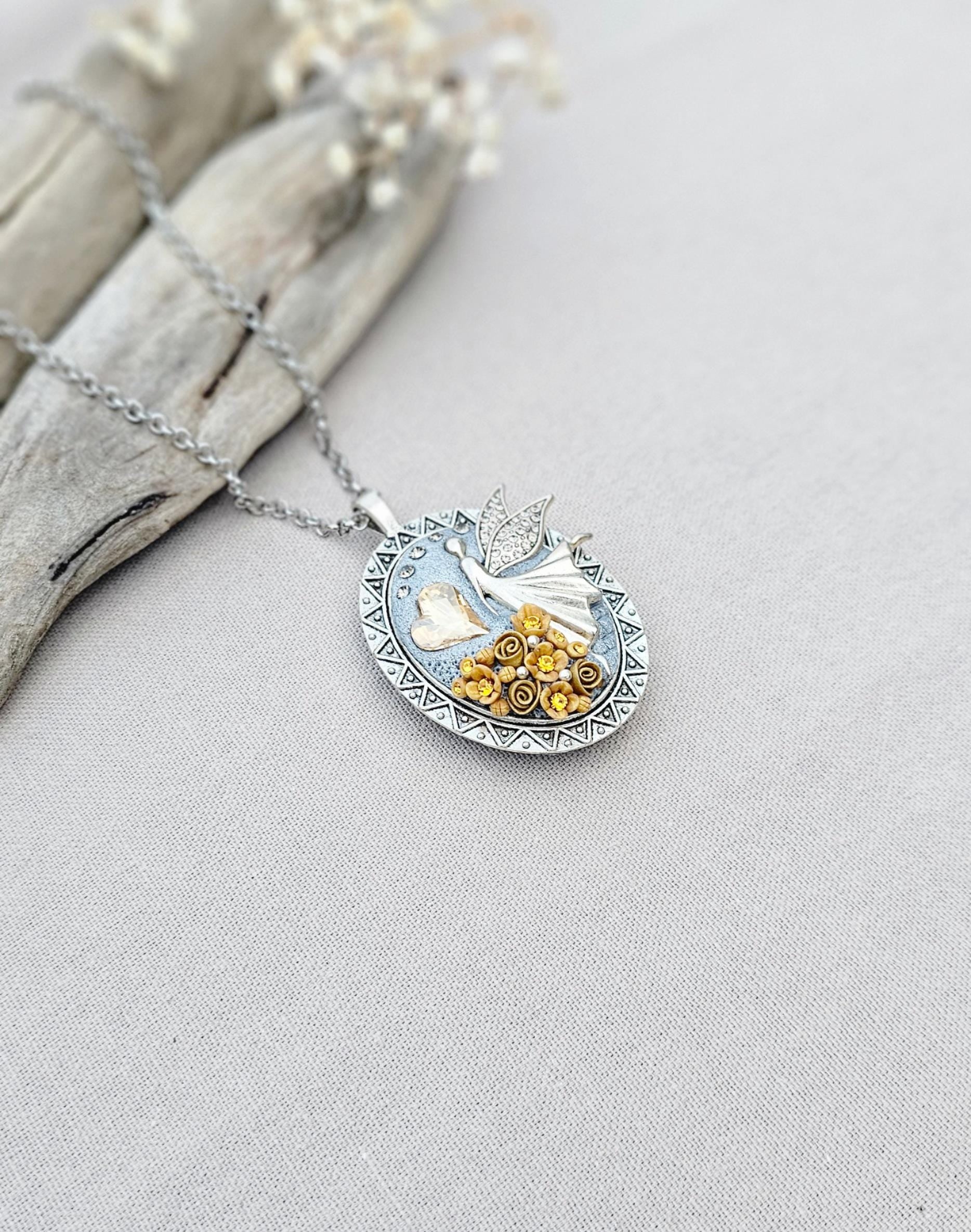 soft gold pendant, fairy locket, floral jewelry, crystal heart necklace, handcrafted pendant, whimsical charm, fairy tale jewelry, unique locket, keepsake necklace, elegant accessory, photo locket, artisan necklace, silver chain pendant