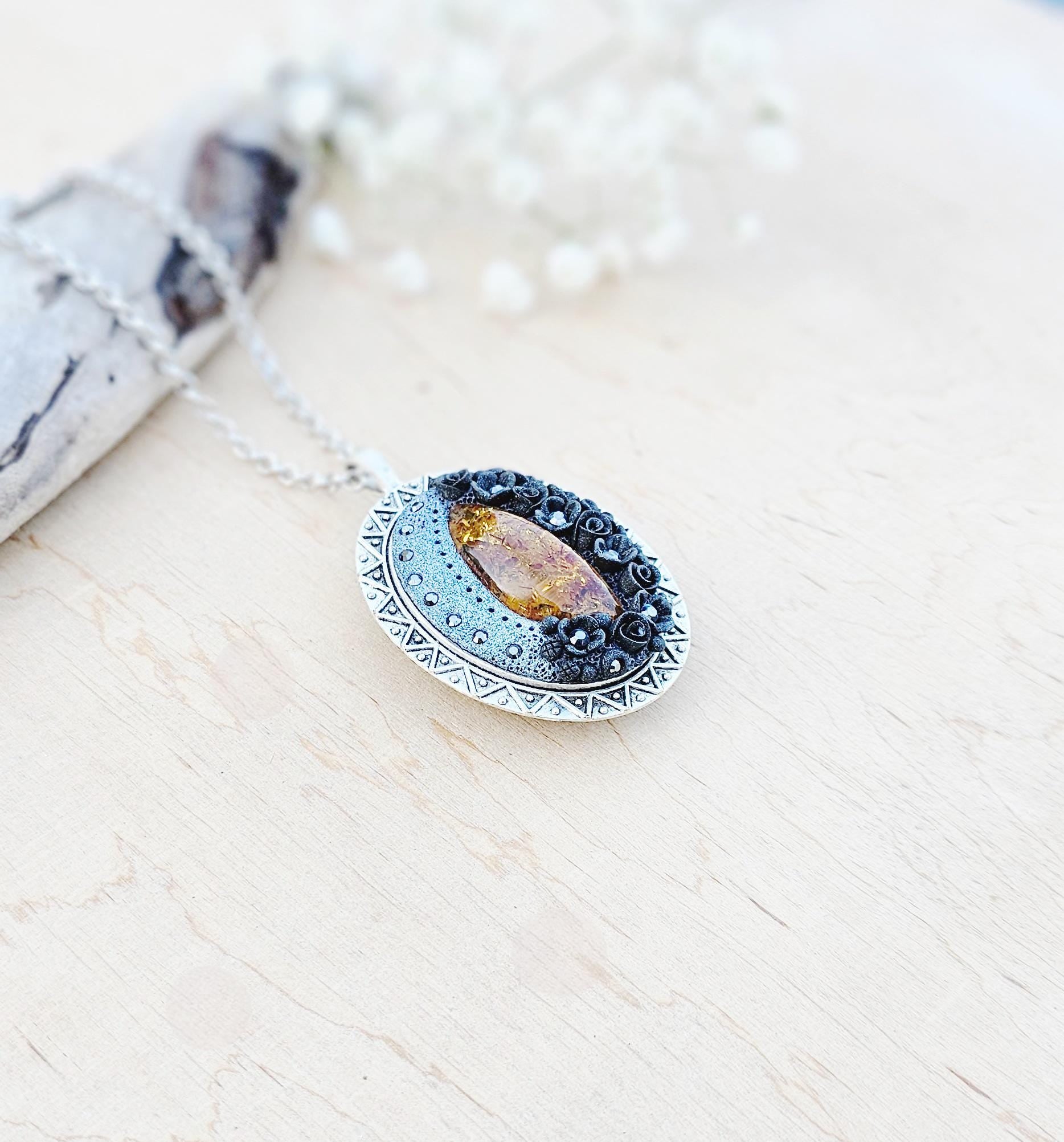 Pendant locket with amber, handmade flowers from polymer clay. On the other side, there is a locket with a heart that opens, inside which you can put a photo or a scent. A great gift for a loved one, or for yourself as a protective amulet.