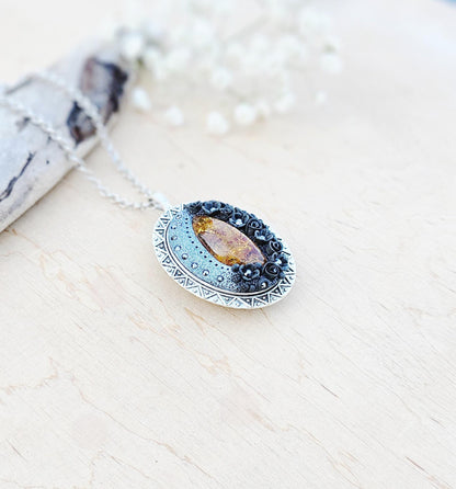 Pendant locket with amber, handmade flowers from polymer clay. On the other side, there is a locket with a heart that opens, inside which you can put a photo or a scent. A great gift for a loved one, or for yourself as a protective amulet.