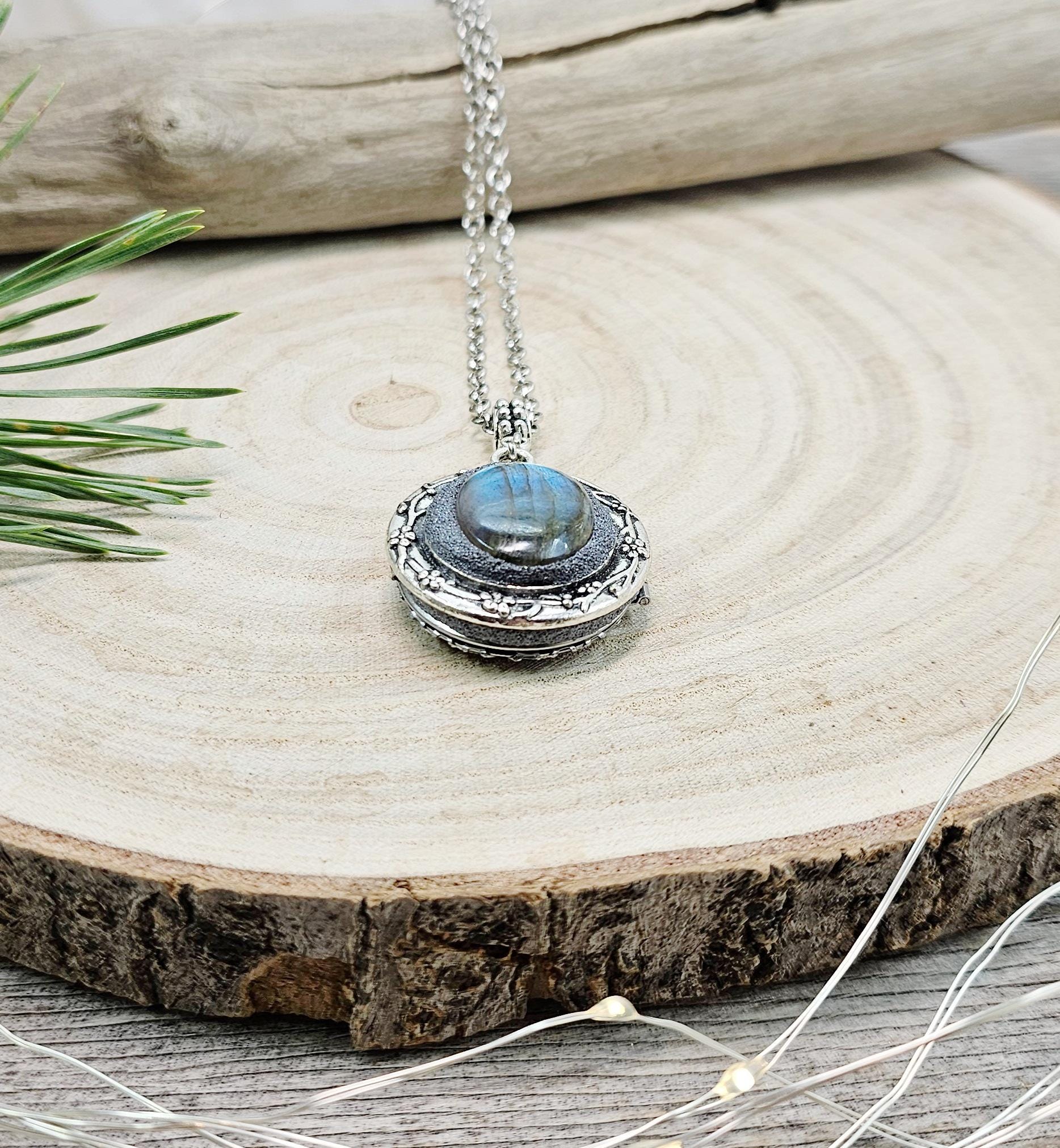 The shimmering labradorite stone, known for its protective and mystical properties, is beautifully framed in polymer clay and set in a silver-tone locket design.