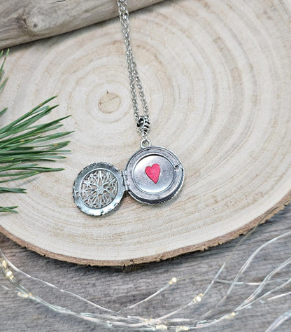 The shimmering labradorite stone, known for its protective and mystical properties, is beautifully framed in polymer clay and set in a silver-tone locket design.