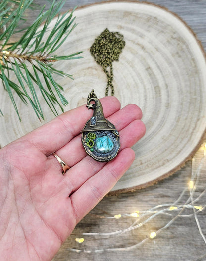 A magical pendant featuring a wizard’s hat, a stunning labradorite stone, and a hidden locket on the other side. Say “Abracadabra” and let your wishes come true!