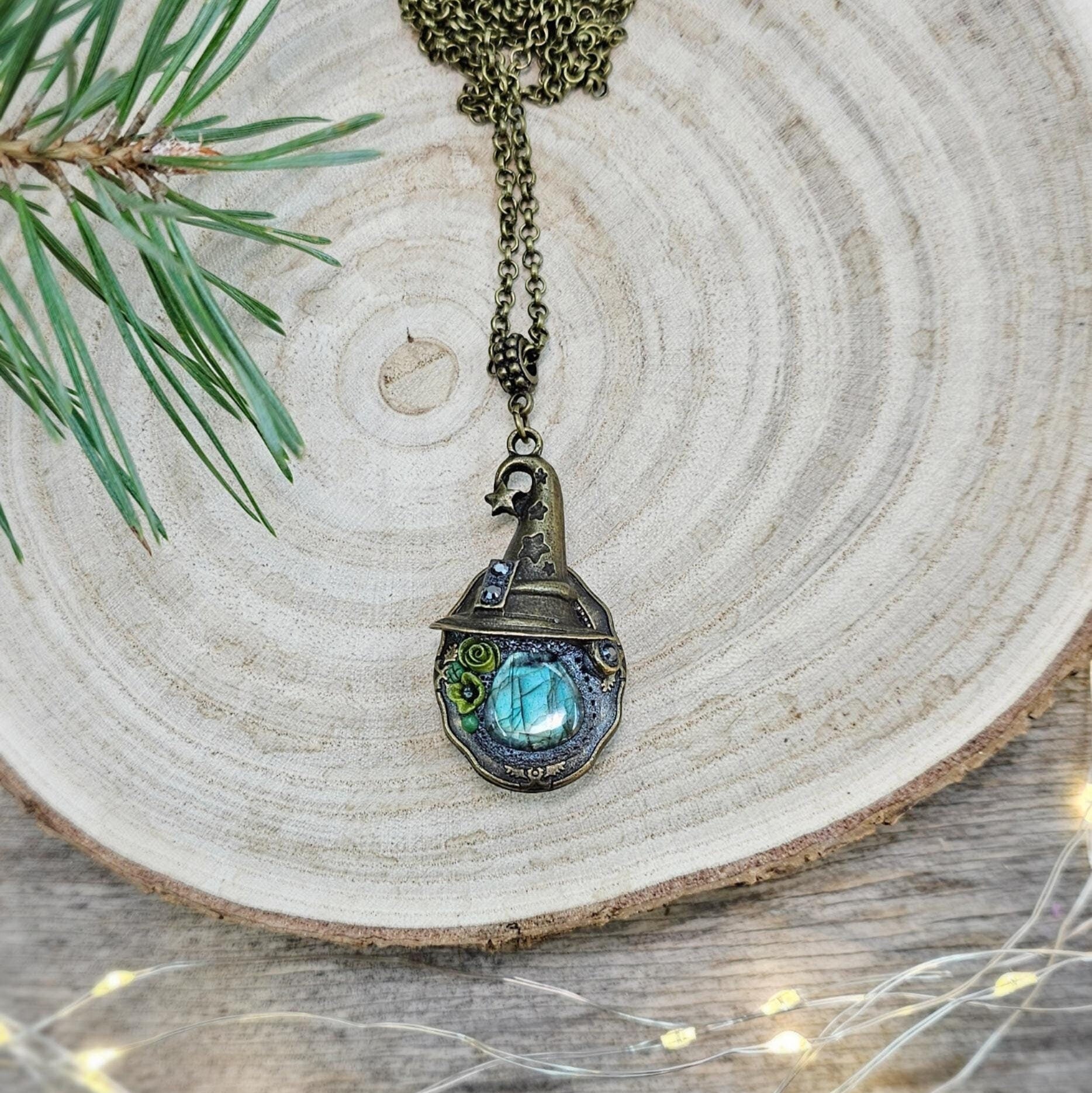A magical pendant featuring a wizard’s hat, a stunning labradorite stone, and a hidden locket on the other side. Say “Abracadabra” and let your wishes come true!