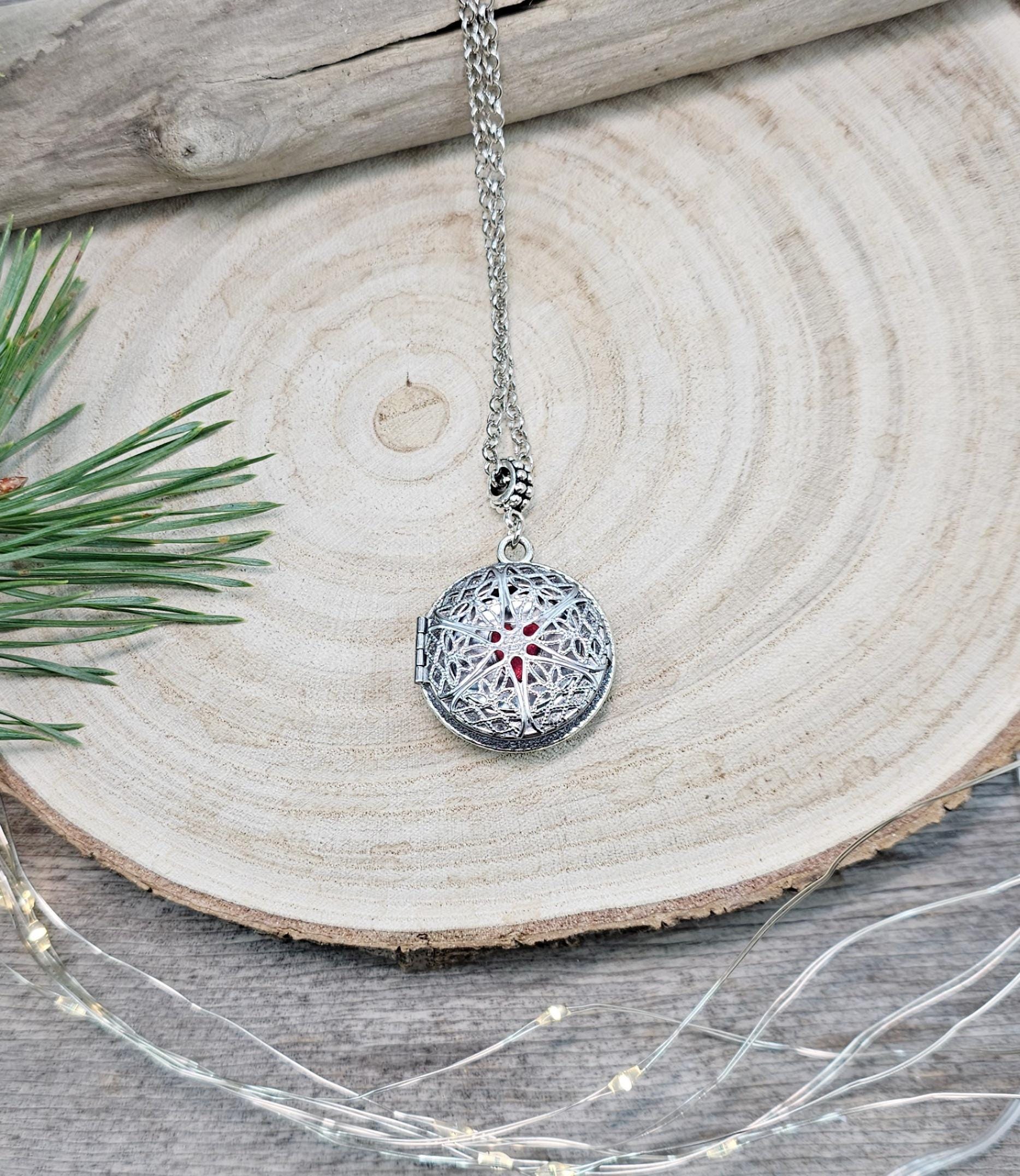 The shimmering labradorite stone, known for its protective and mystical properties, is beautifully framed in polymer clay and set in a silver-tone locket design.