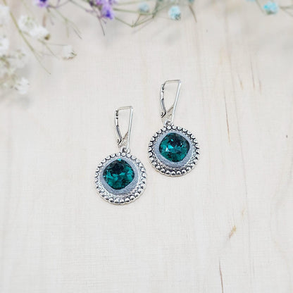 Elegant dangle earrings with sparkling emerald color crystals set in metal frames with polymer clay details. Silver hooks. Packaged in a paper gift box. A perfect accessory for any occasion, adding a touch of brilliance and sophistication