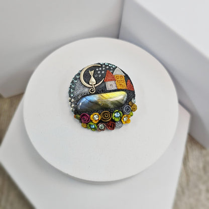 Handmade polymer clay brooch with labradorite and metal cat – magical, nature-inspired accessory for cat lovers.