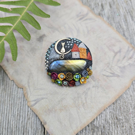 Handmade polymer clay brooch with labradorite and metal cat – magical, nature-inspired accessory for cat lovers.