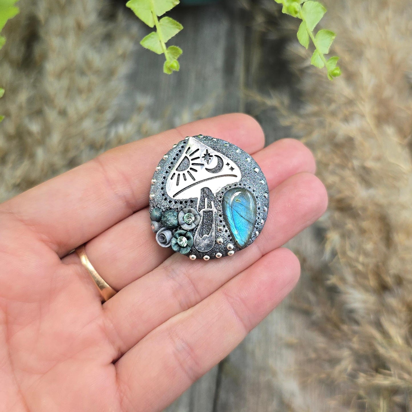 Handmade polymer clay brooch featuring a magical mushroom and a glowing labradorite stone, with stainless steel pin – forest-inspired mystical jewelry.
